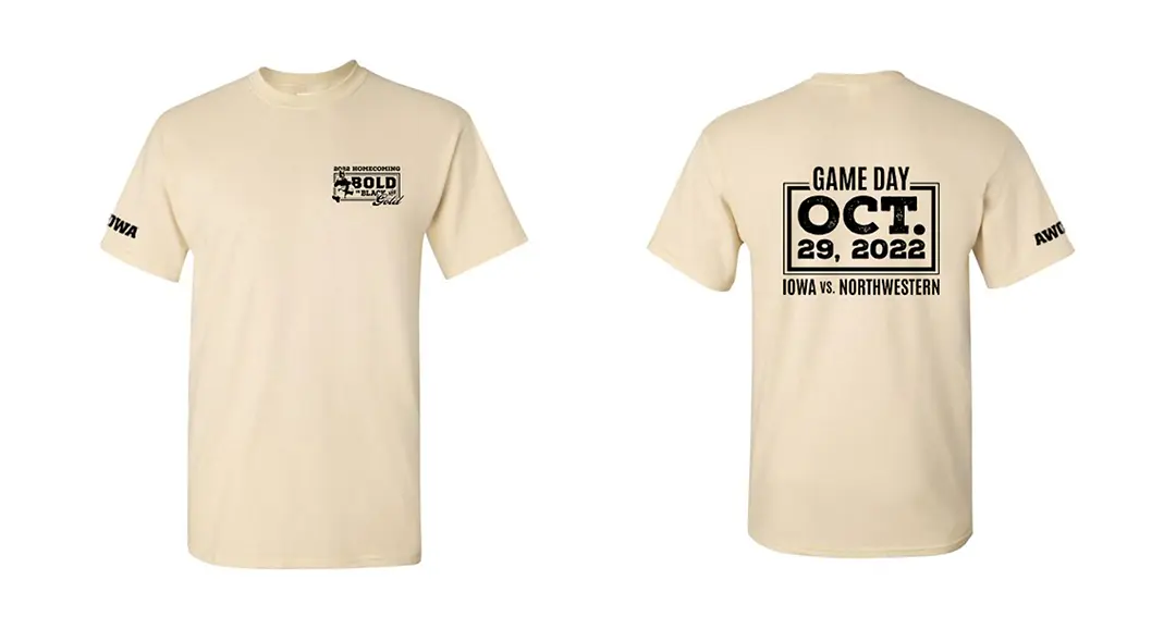 Mockup of a cream colored short-sleeve t-shirt printed in black with the homecoming wordmark on the lapel, the 
                        Iowa logo on the sleeve, and gameday information on the back in a bordered box.