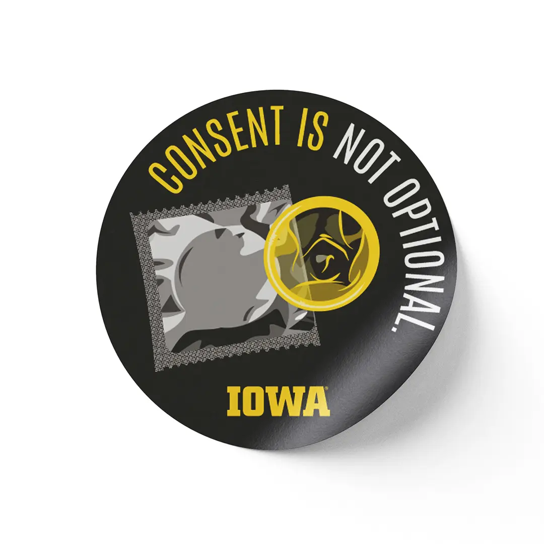 Round sticker with an illustration of a wrapped and unwrapped condom on a black background. 
                        Text around the outer edge says 'CONSENT IS NOT OPTIONAL.