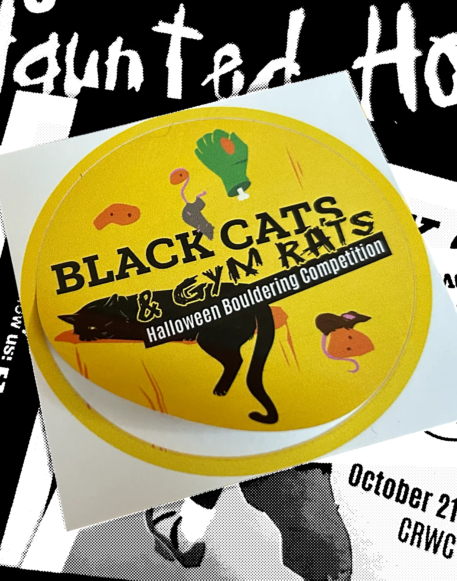 Round sticker for Black Cats & Gym Rats featuring a cat lounging on a ledge and rats climbing on orange hand holds on a yellow climbing wall.