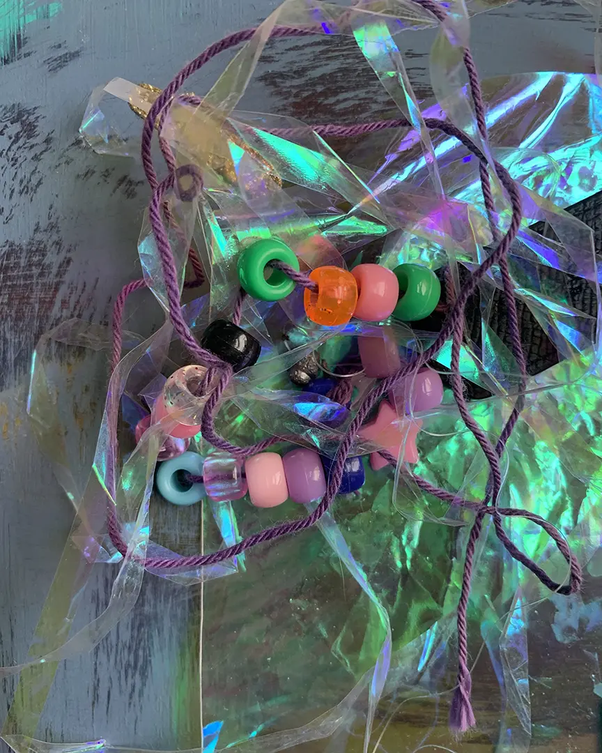 Close up of a mass of strung beads and plastic