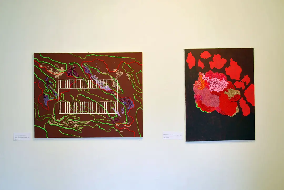 Two bead paintings. The one on the left has a brownish background with red, purple, and 
                        green lines of beads in squiggle patterns. In the center is a white grid. The painting on the right 
                        has a grey background with red splotches. The biggest splotch in the center is covered in 
                        multicolored beads.