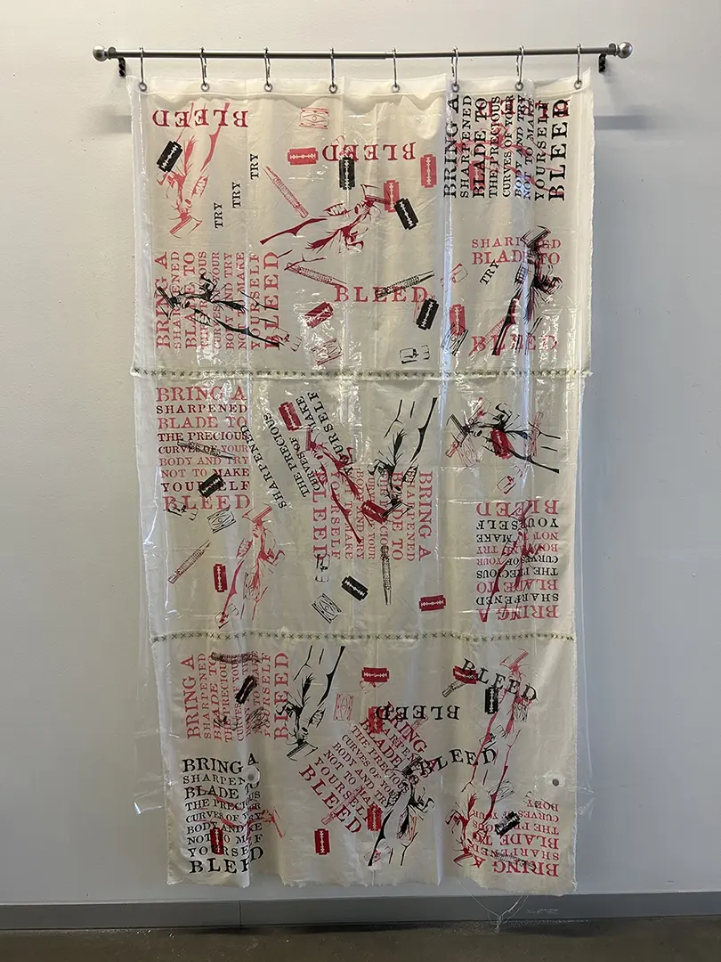 Shower curtain hanging from a curtain rod on a white wall. Printed on the inner 
                            muslin curtain in pink, red, and black are images of razor blades and text about body 
                            hair removal. There's a plastic curtain in front of the print.