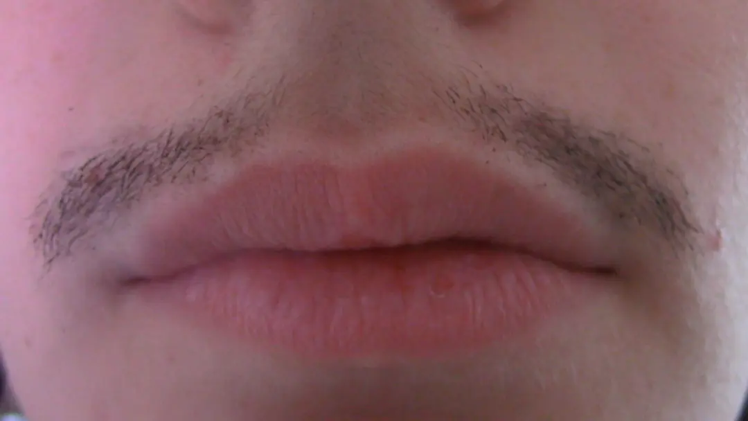 Close up of Kate's mouth with mascara on his mustache.